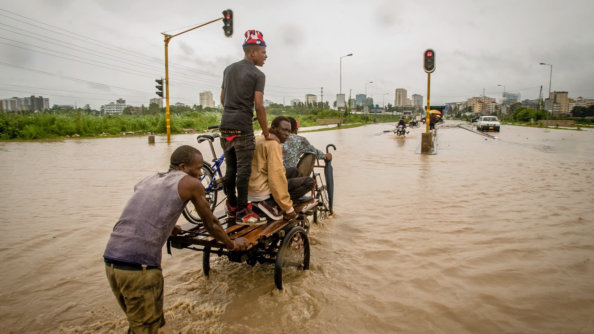 Youth population in Dar es Salaam traveling through flooded waters during recent flood episode.