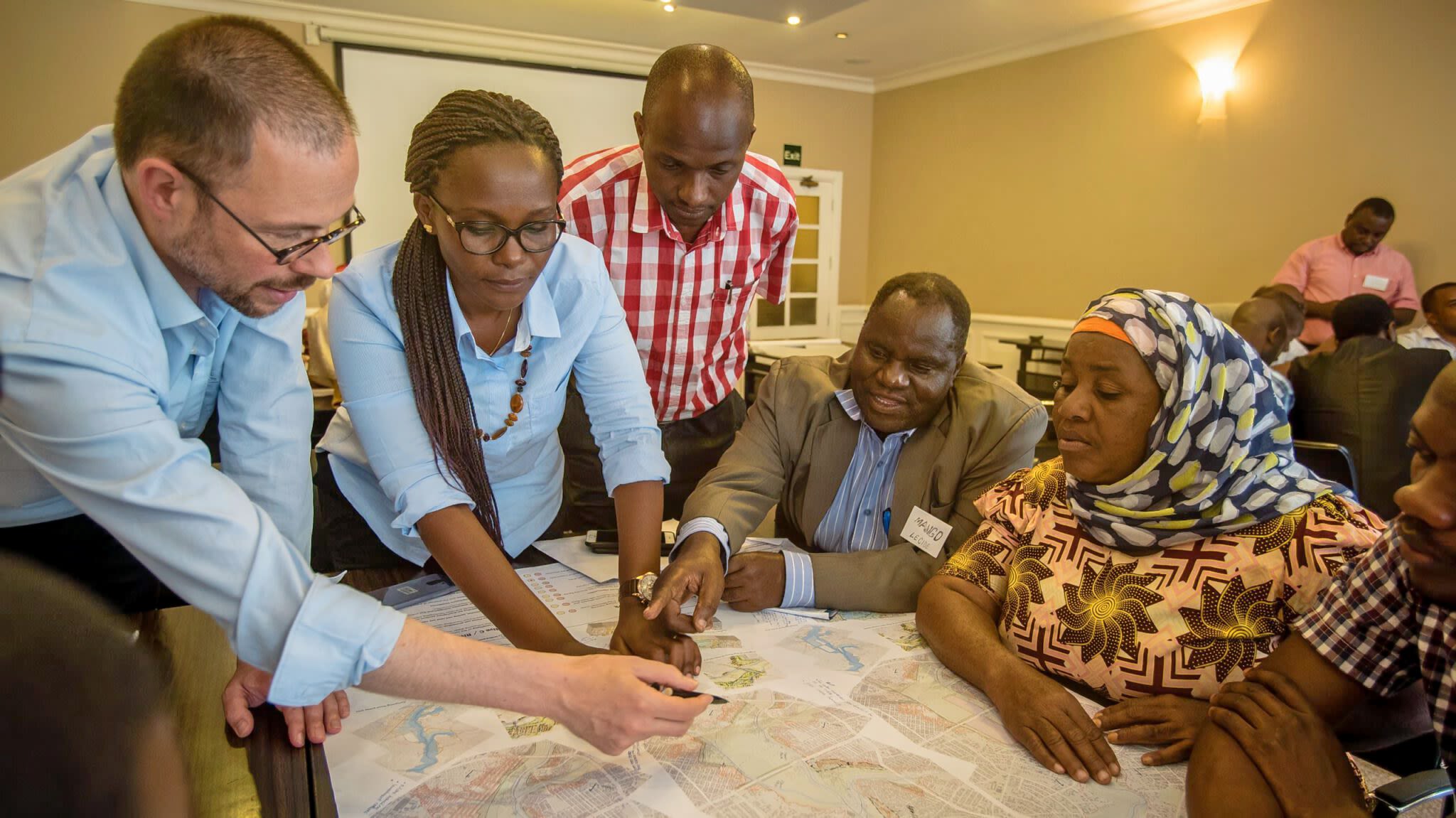 Workshop participants discuss flood risk zones using a paper map